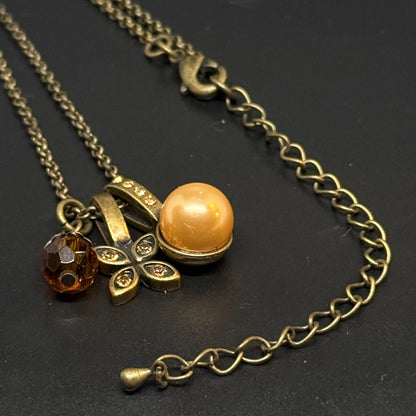 Necklace with pendant in antique gold-colored metal