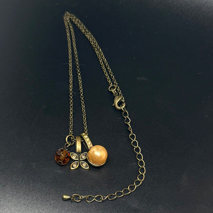 Necklace with pendant in antique gold-colored metal